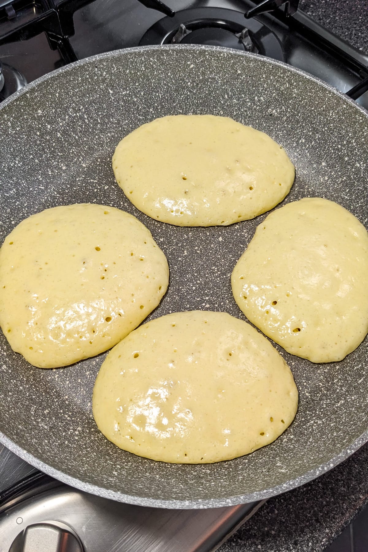 Frying pan with 4 pancakes made with condensed milk.