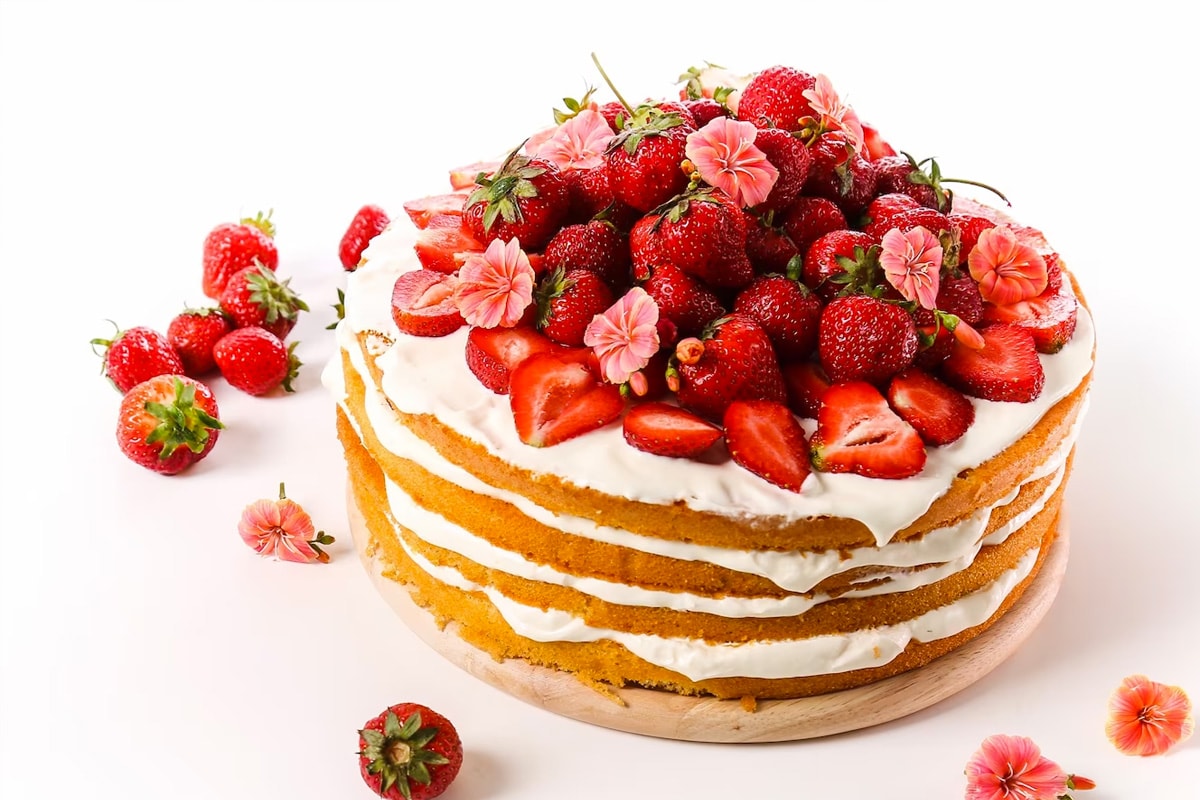 Close look of strawberry cake with a few layers of cream.