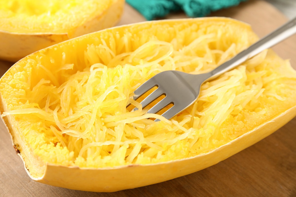 Close look of spaghetti squash with a fork in it.