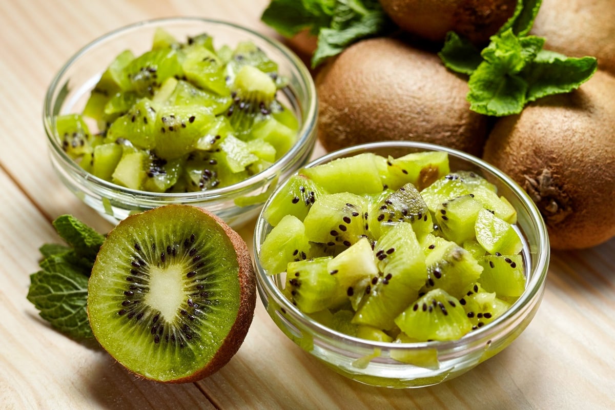 Close look of two transparent bowls with small cutted pieces of kiwi.