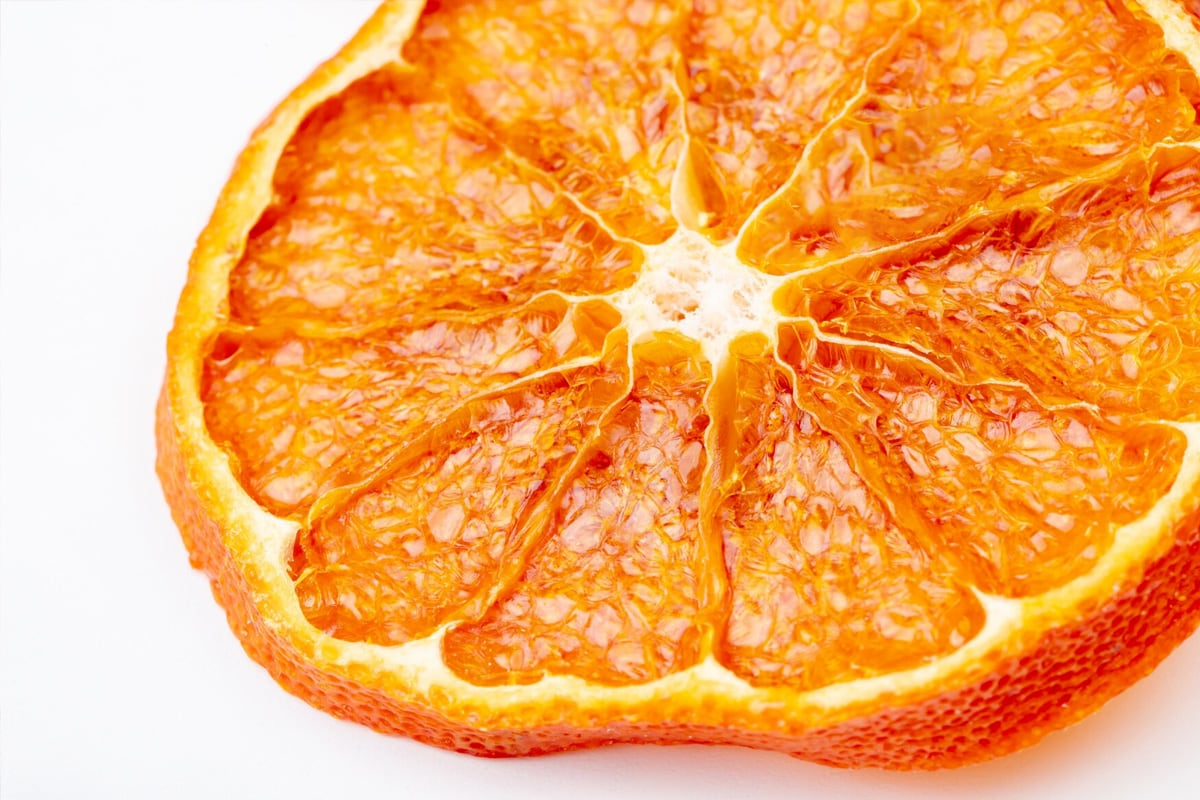 Close look of a seedless red orange on a white background.