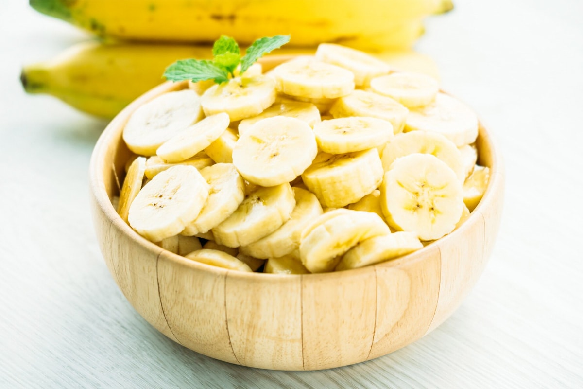 A wooden bowl with thawed banana slices.