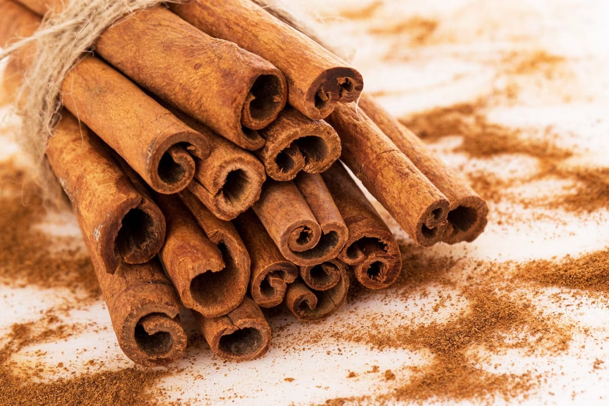 Close look of cinnamon sticks near cinnamon powder.