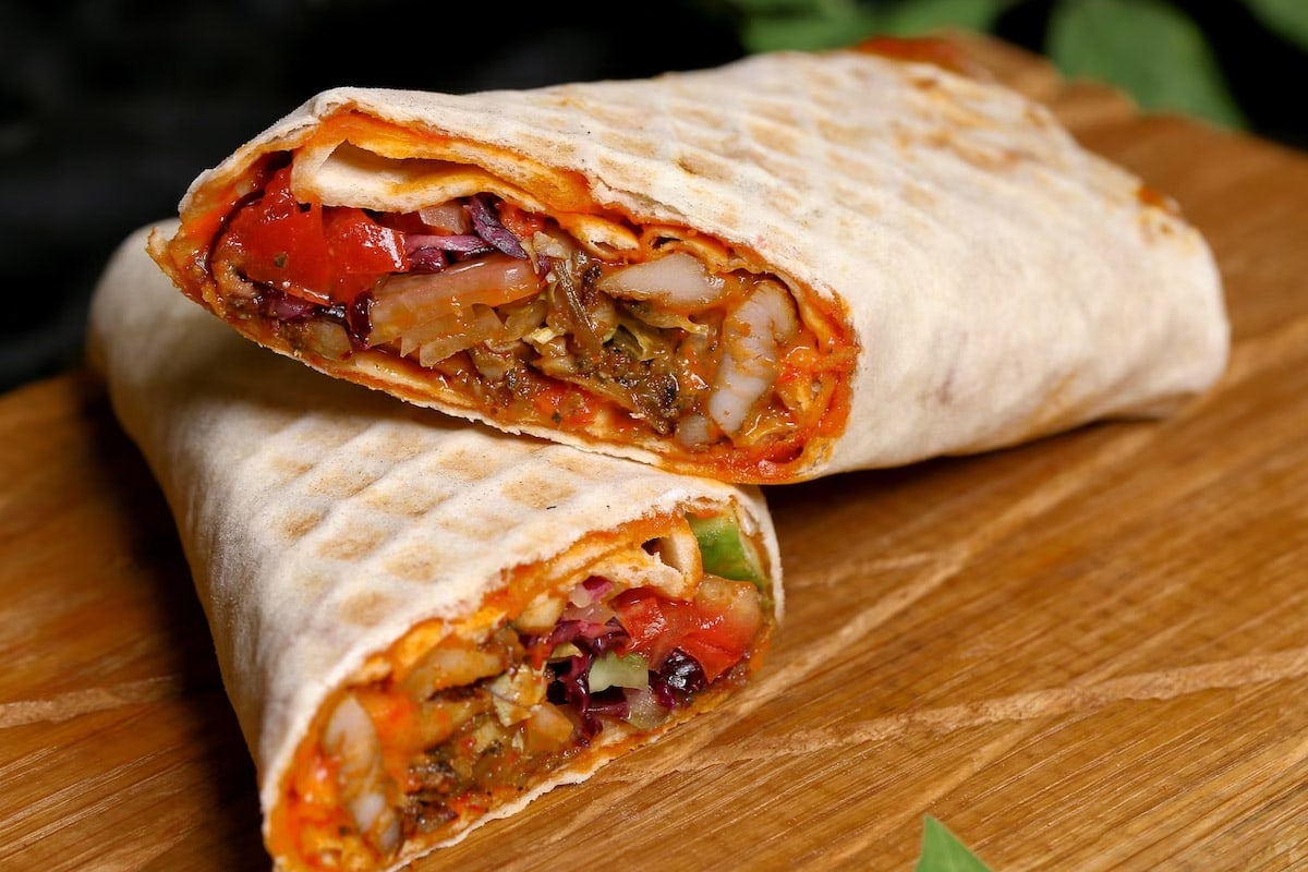 Close look of two halves of burritos sitting on each other.