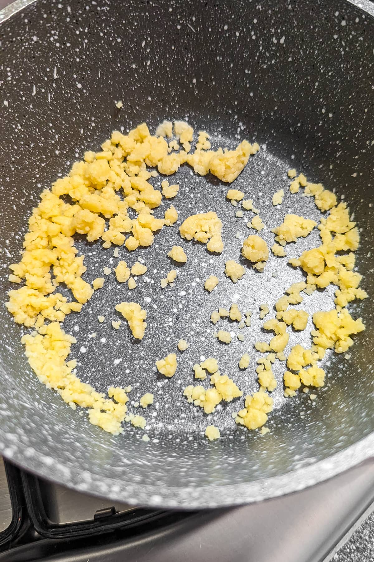Close look of mixed all-purpose flour and butter in a saucepan.