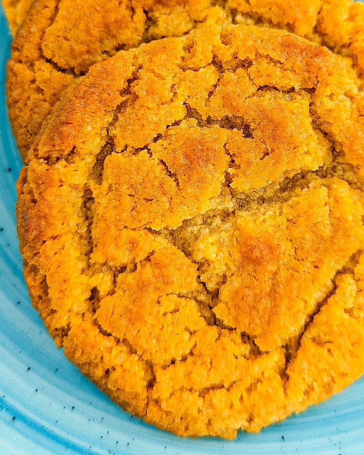 Close look of crumbly caramel biscuits on a blue plate.