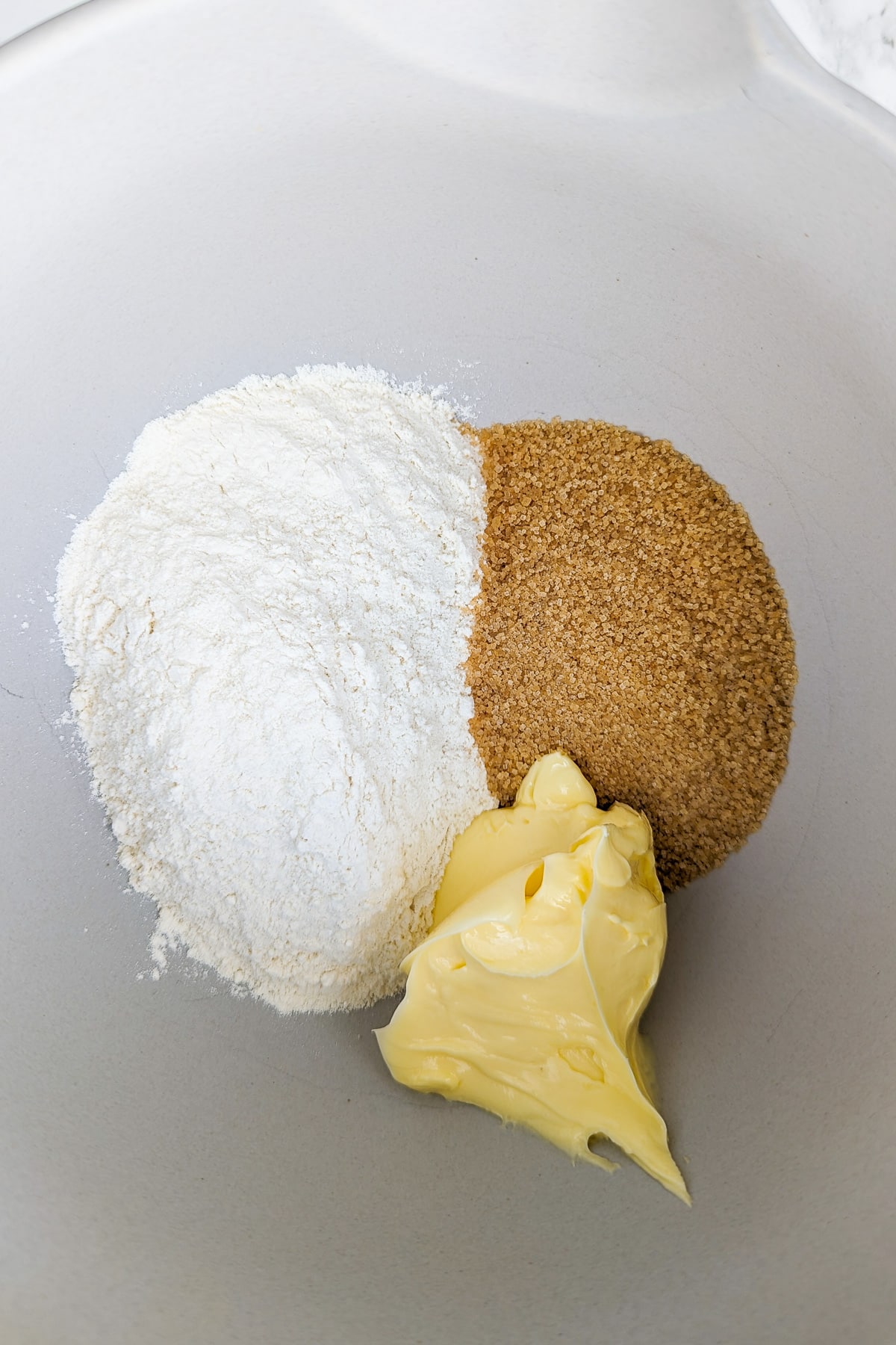 Deep bowl with flour, sugar and butter.