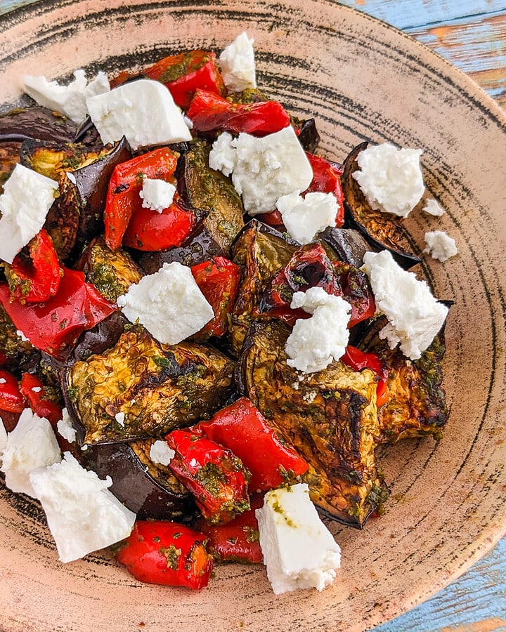 Rustic plate with eggplant, bell peppers and feta cheese salad.