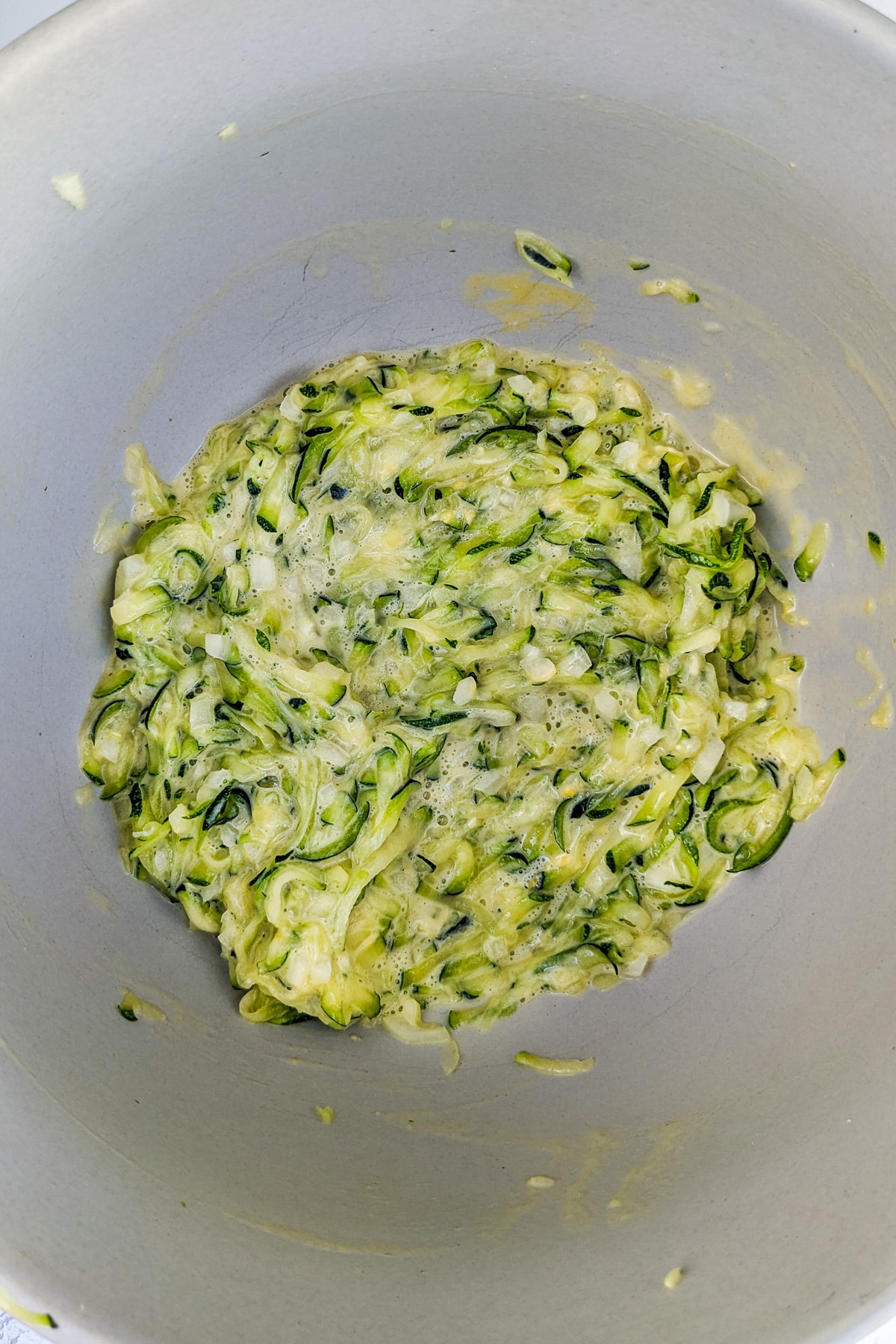 Zucchini fritters mix in a deep bowl.