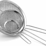 Set of 3 sieves of different sizes on white background.