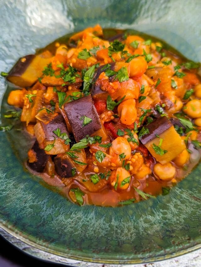 Vintage green plate with eggplant and chickpea stew.