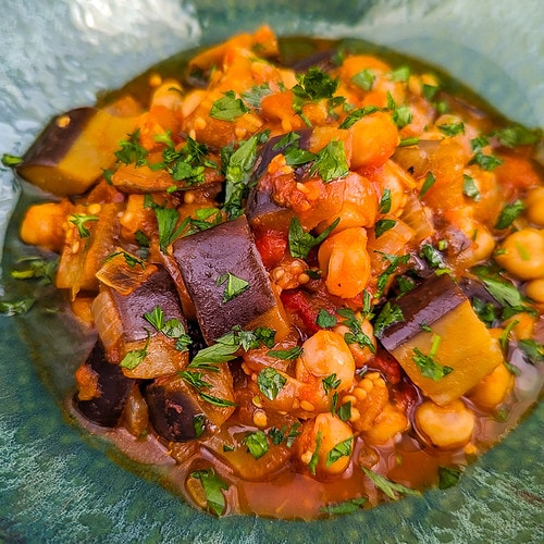 Vintage green plate with eggplant and chickpea stew.