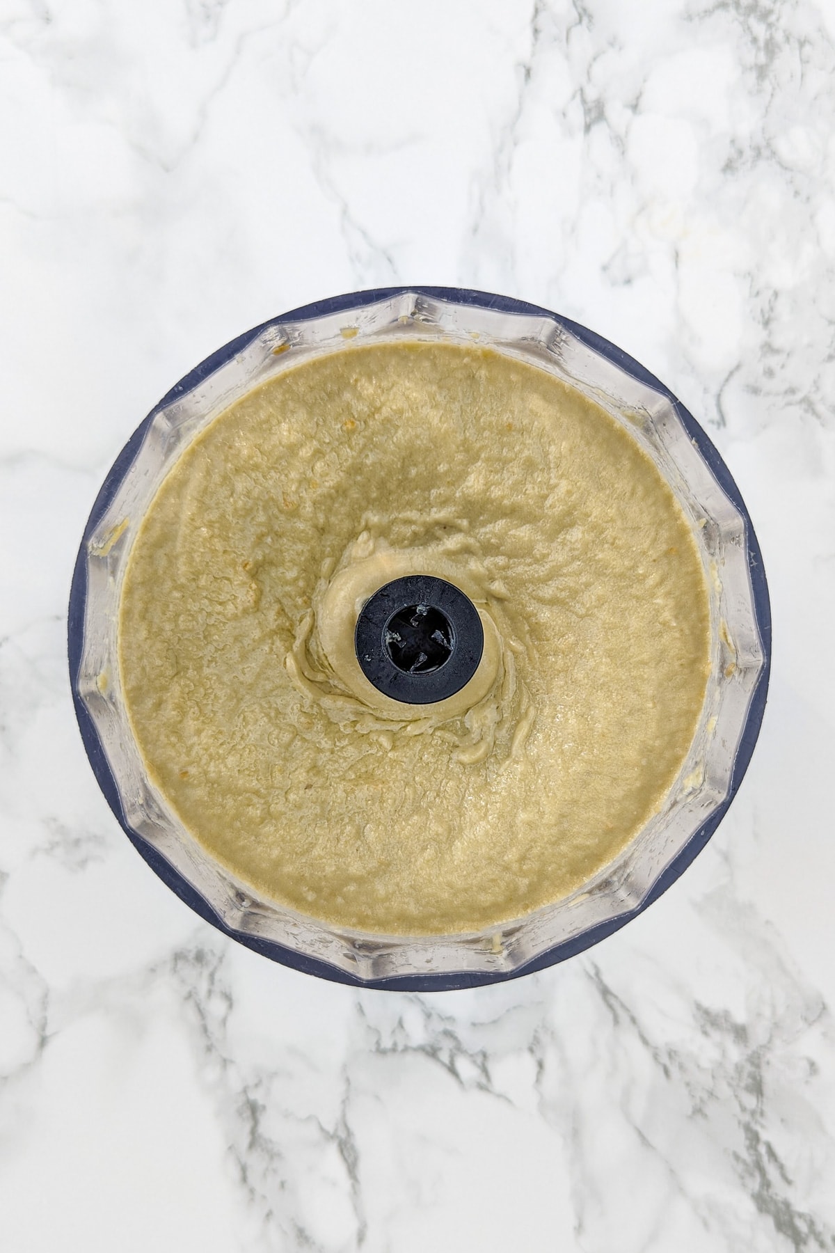 Top view of eggplant dip with tahini in a table mixer.