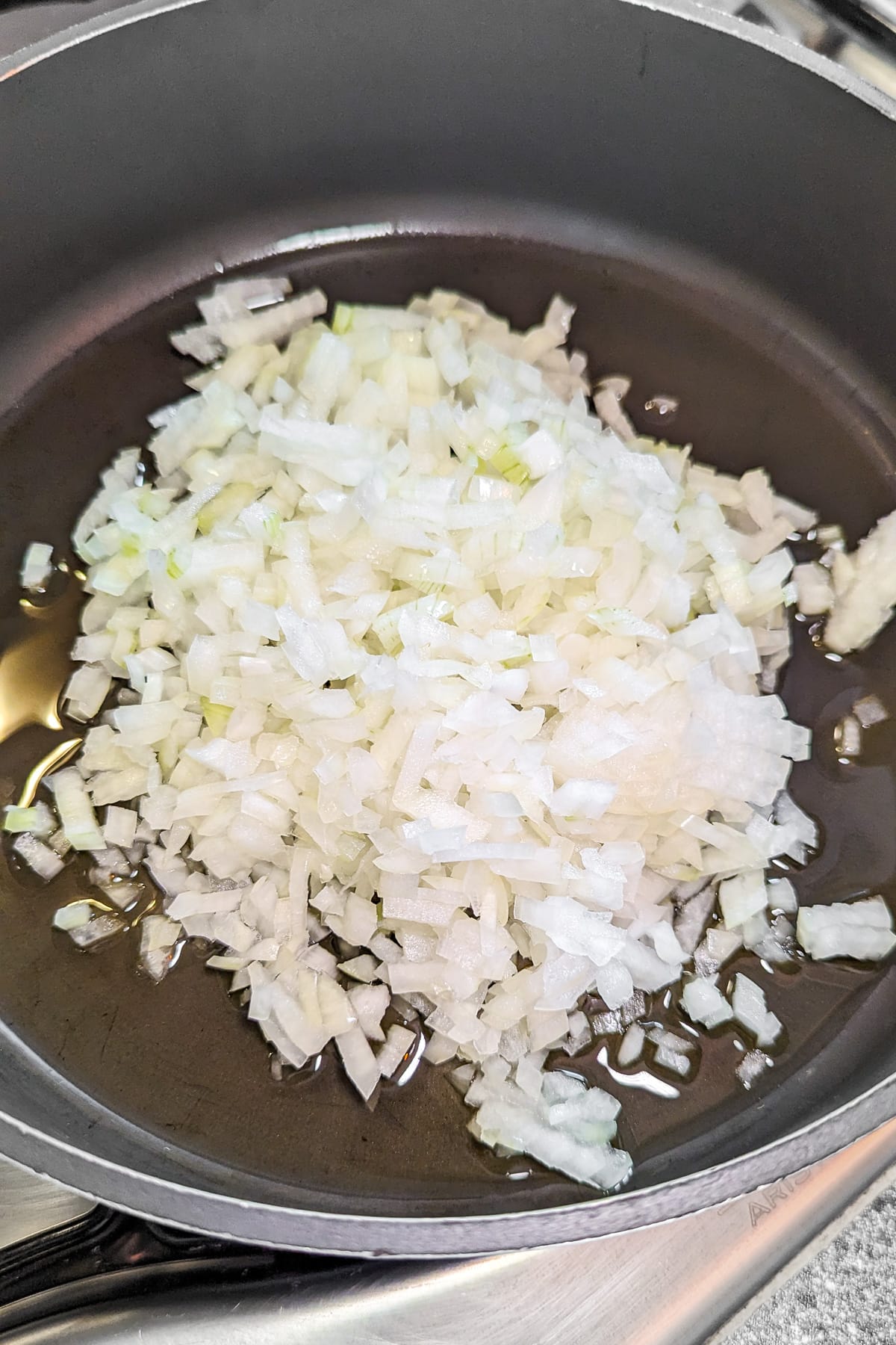 Diced onion in a frying pan with a little bit of oil.
