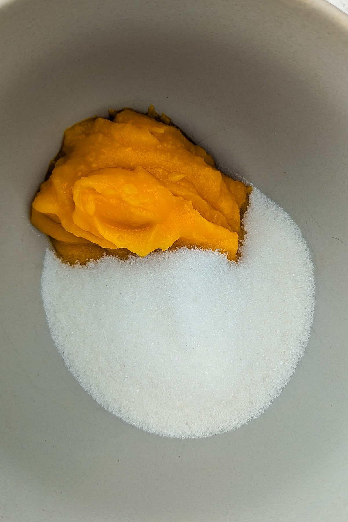 Sugar and pumpkin puree in a large bowl.