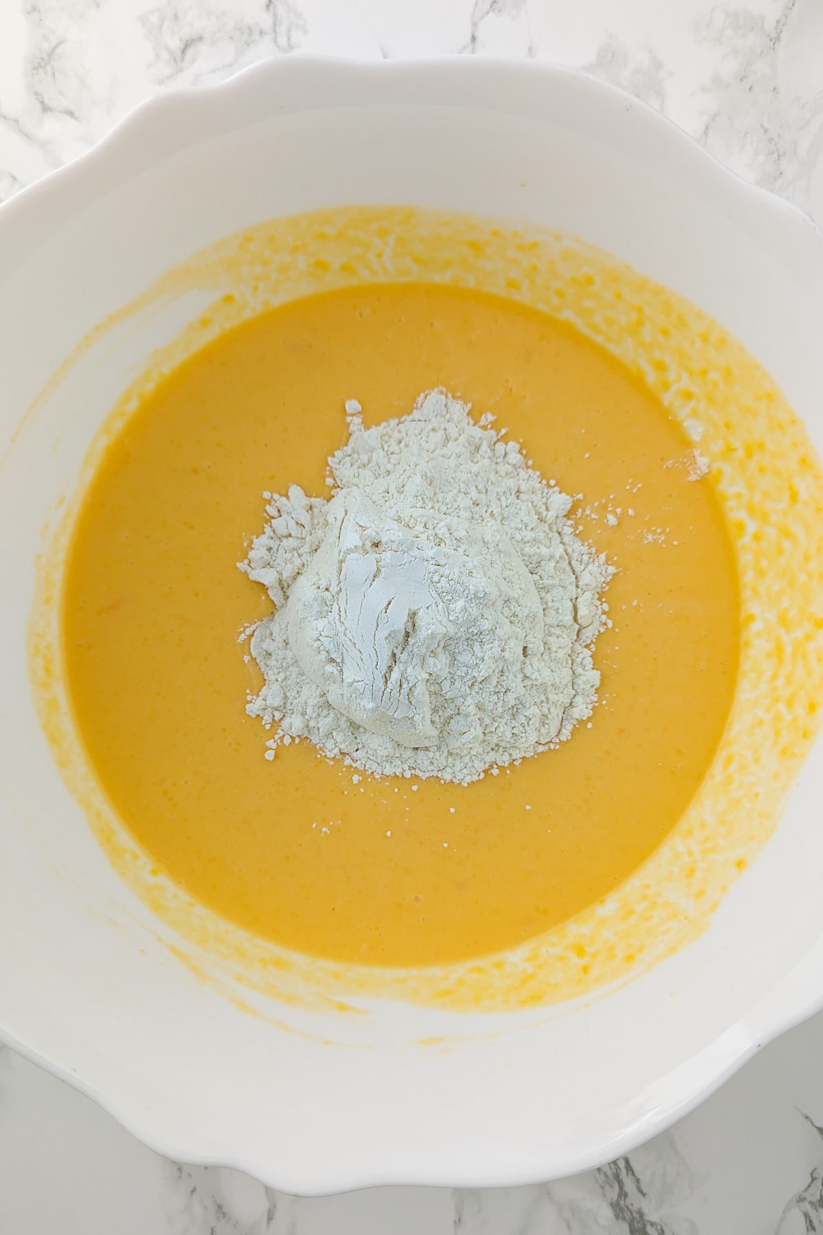 Top view of homemade pumpkin pancake mix in a large white bowl.