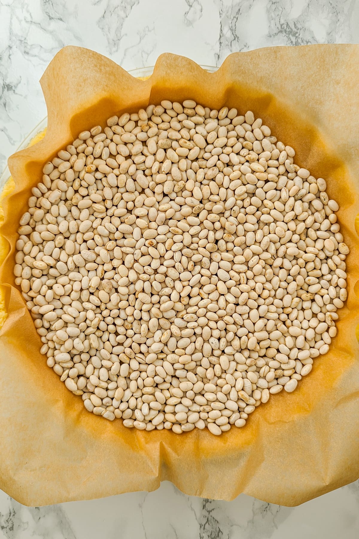 Top view of beans covered the tart of the pie.