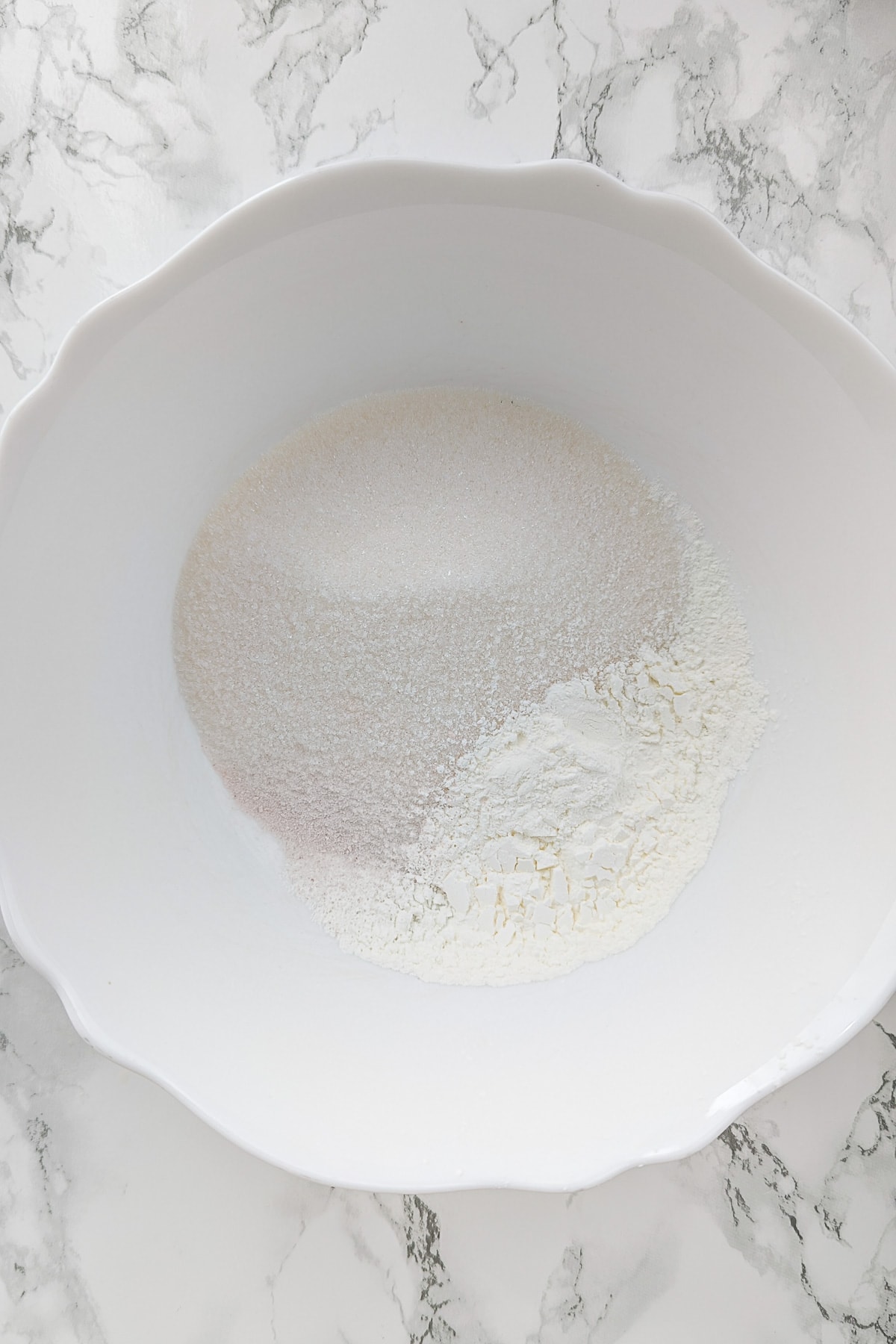 Top view of a white plate with starch and sugar.