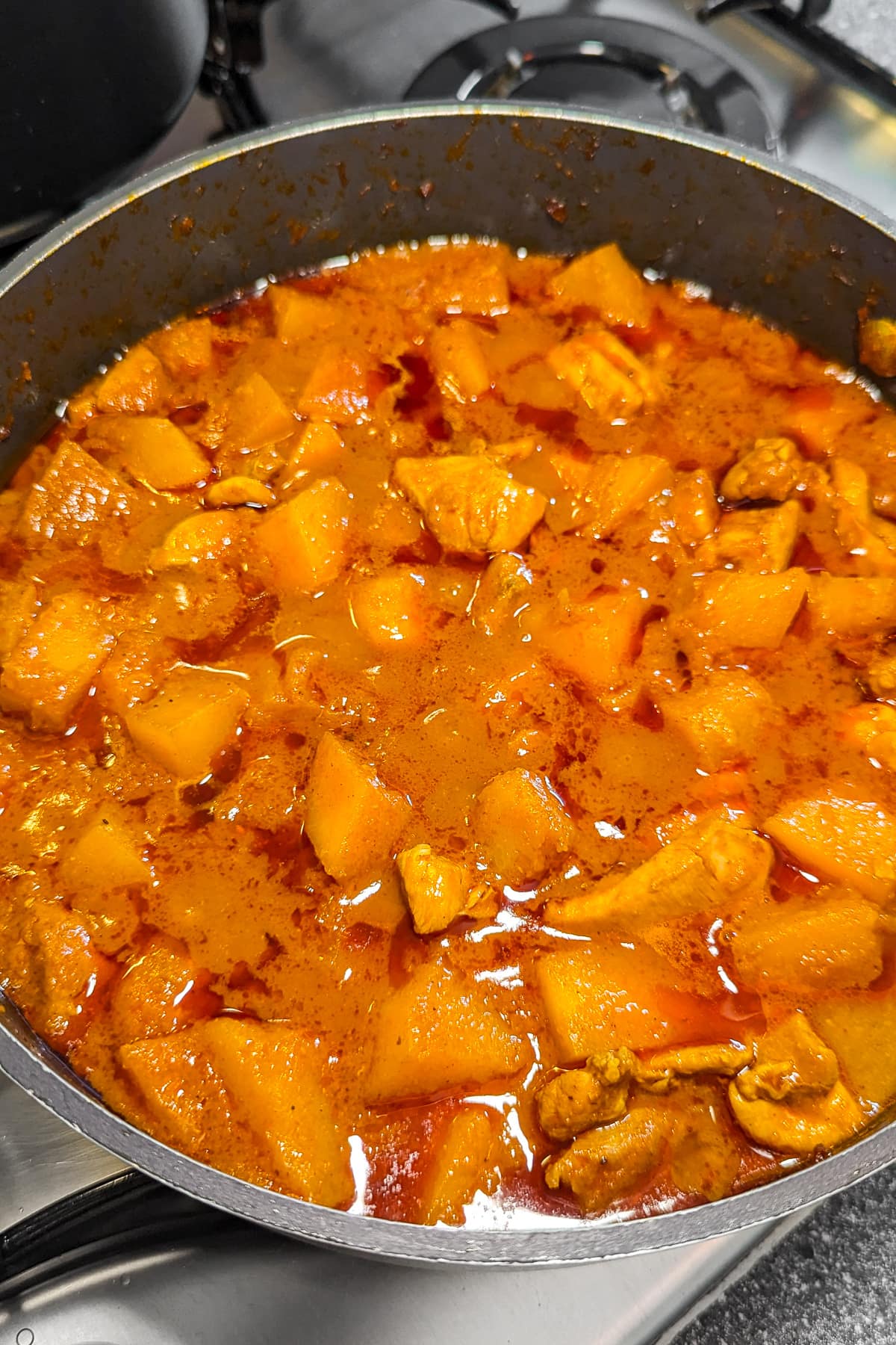 Pumpkin curry in a pan on the stove.