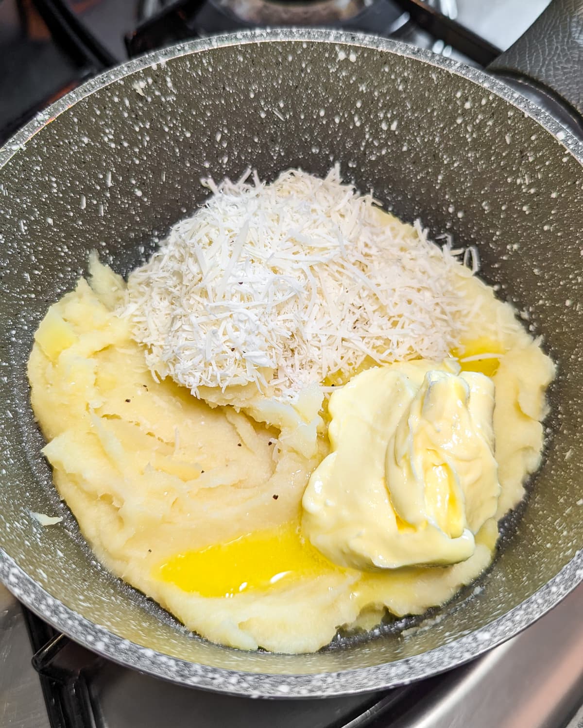 Pan with mashed parsnips, grated parmesan and melted butter.