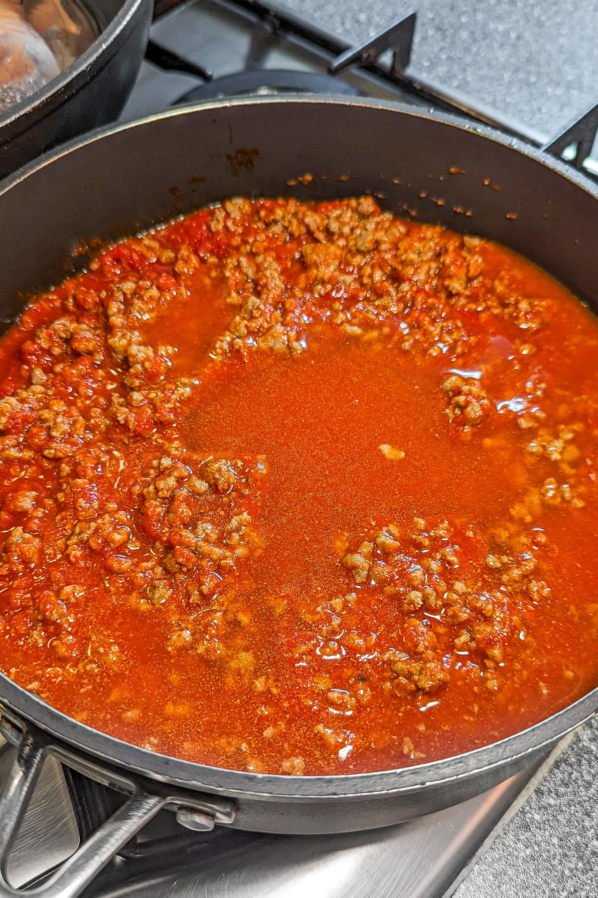 Beef chili in a pan on the stove.