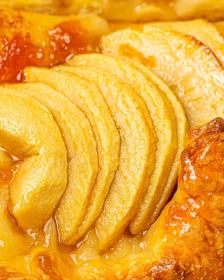 Close-up of the apple tart showing the caramelized edges and glazed apple topping.
